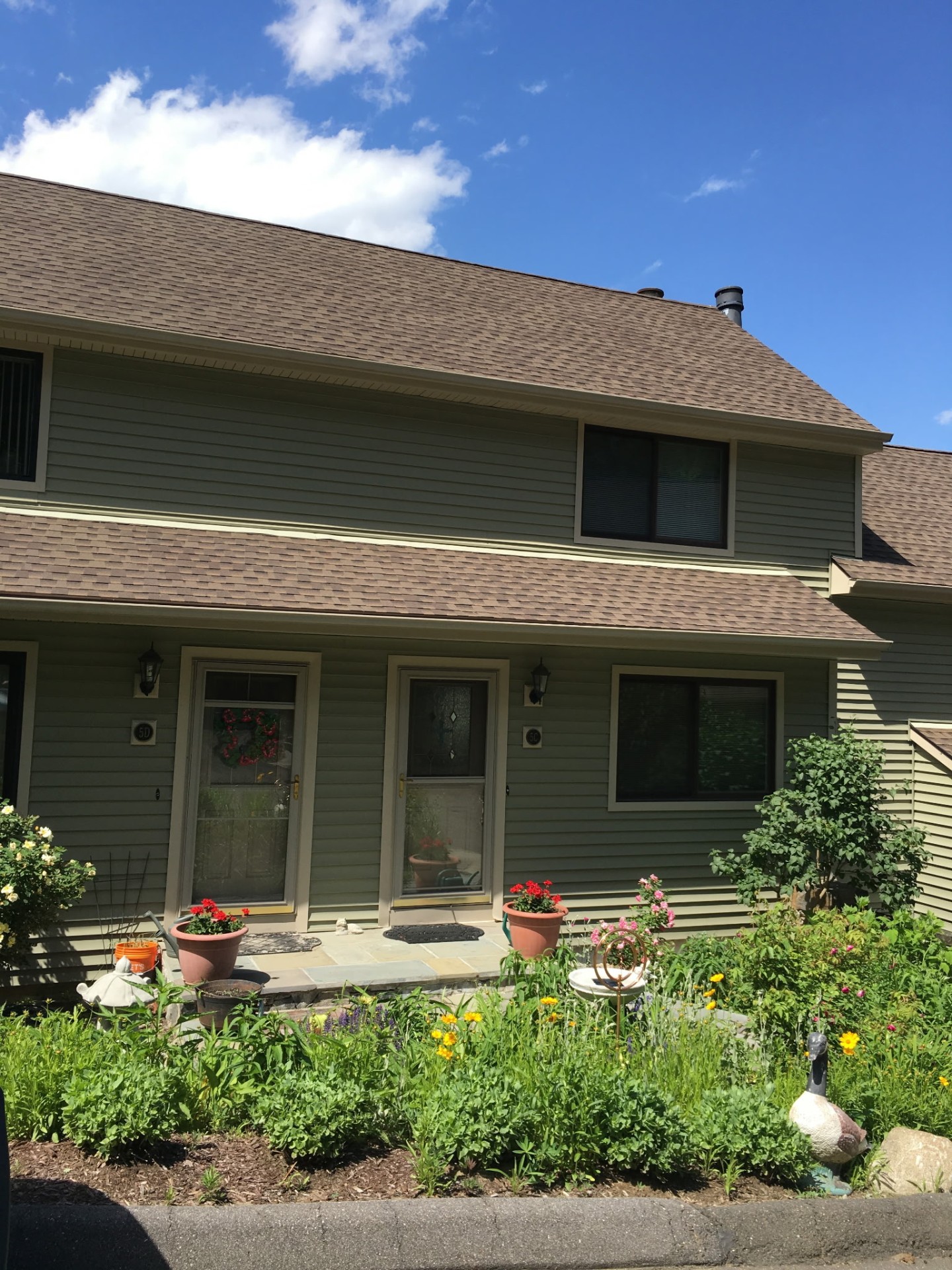 Finished townhome exterior with new charcoal architectural shingle roof